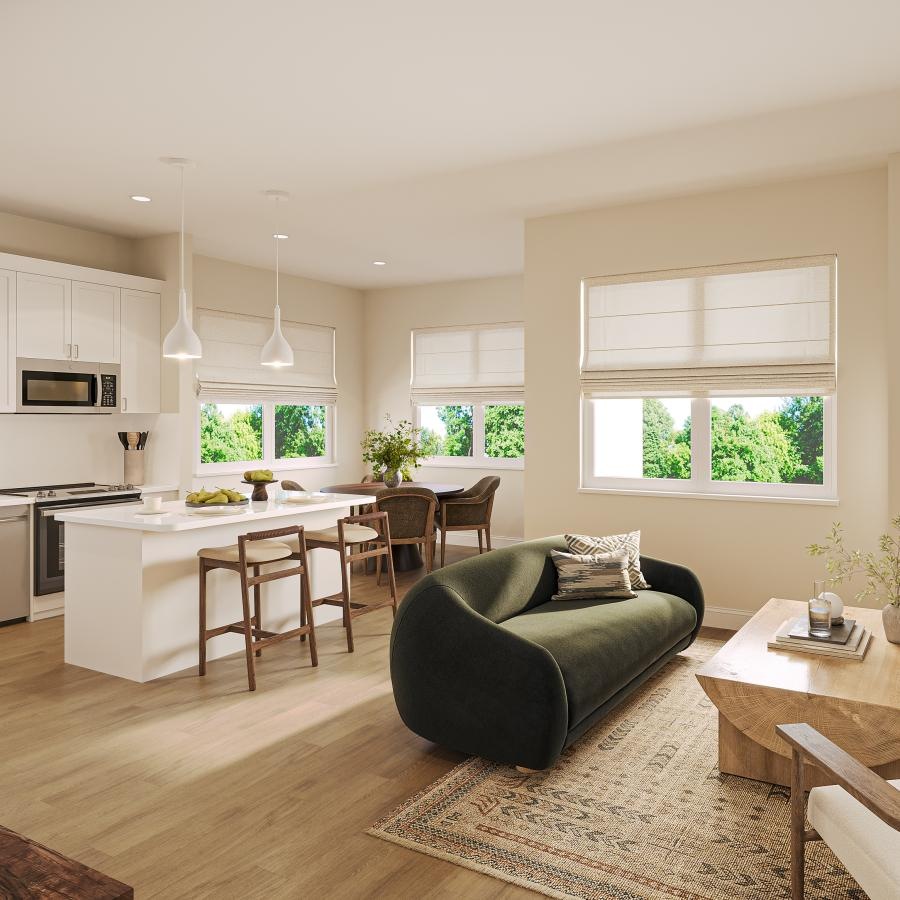 a living room with a couch and table and view of a kitchen