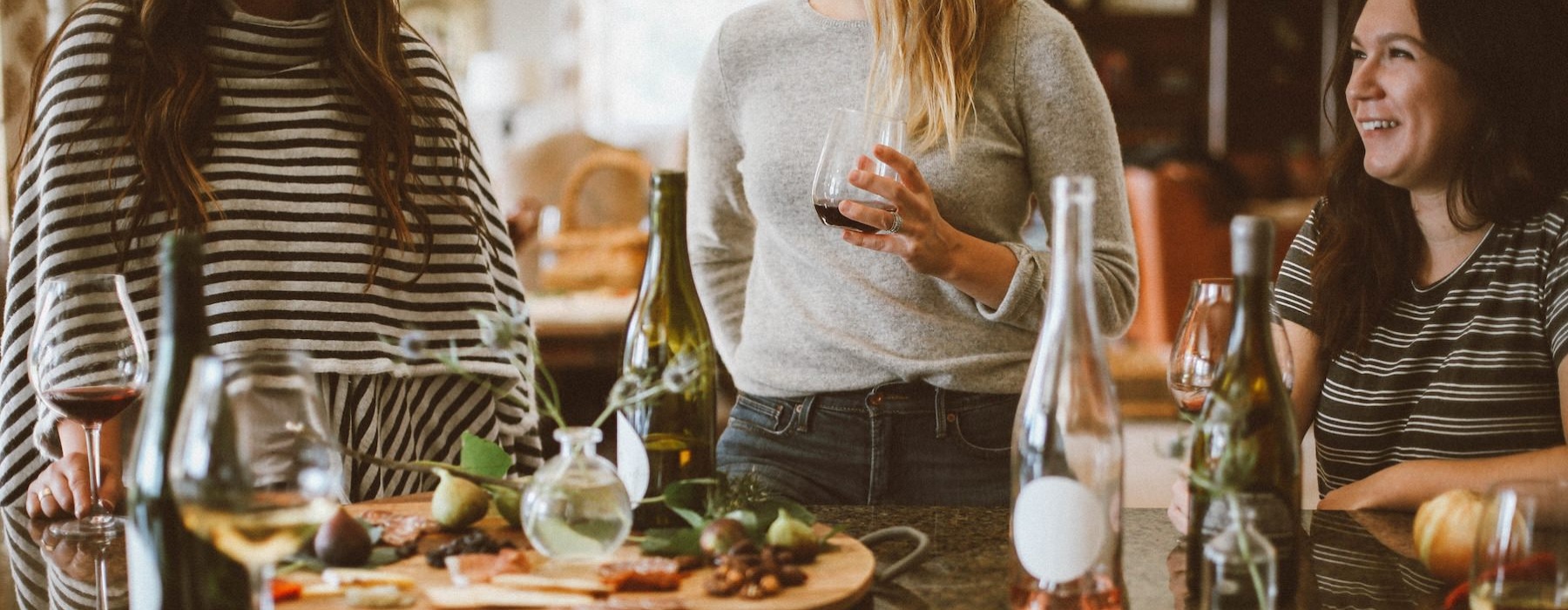 women having food and drinks at a table