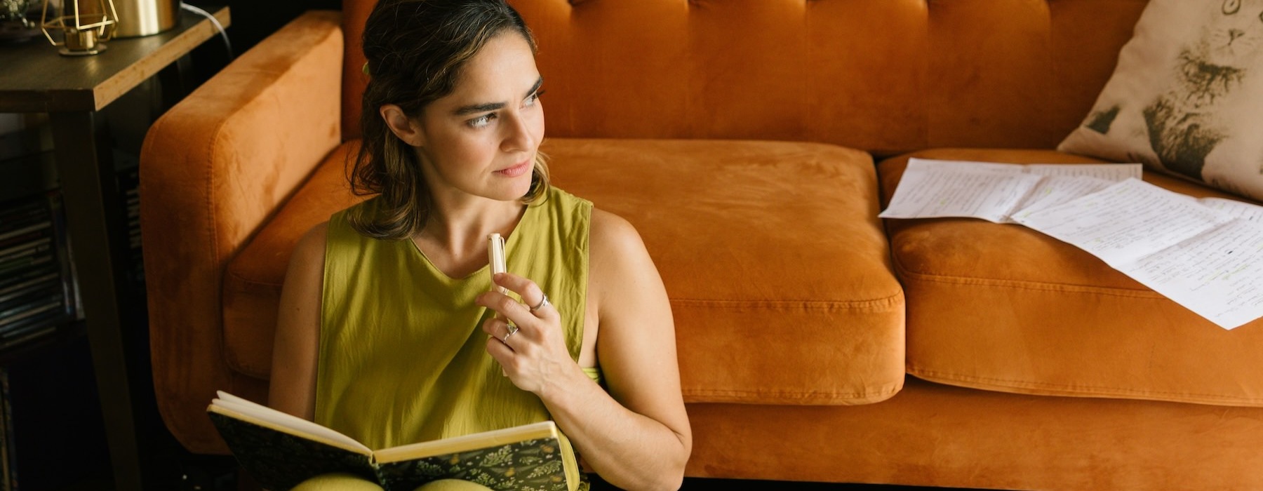 a person sitting on a couch reading a book